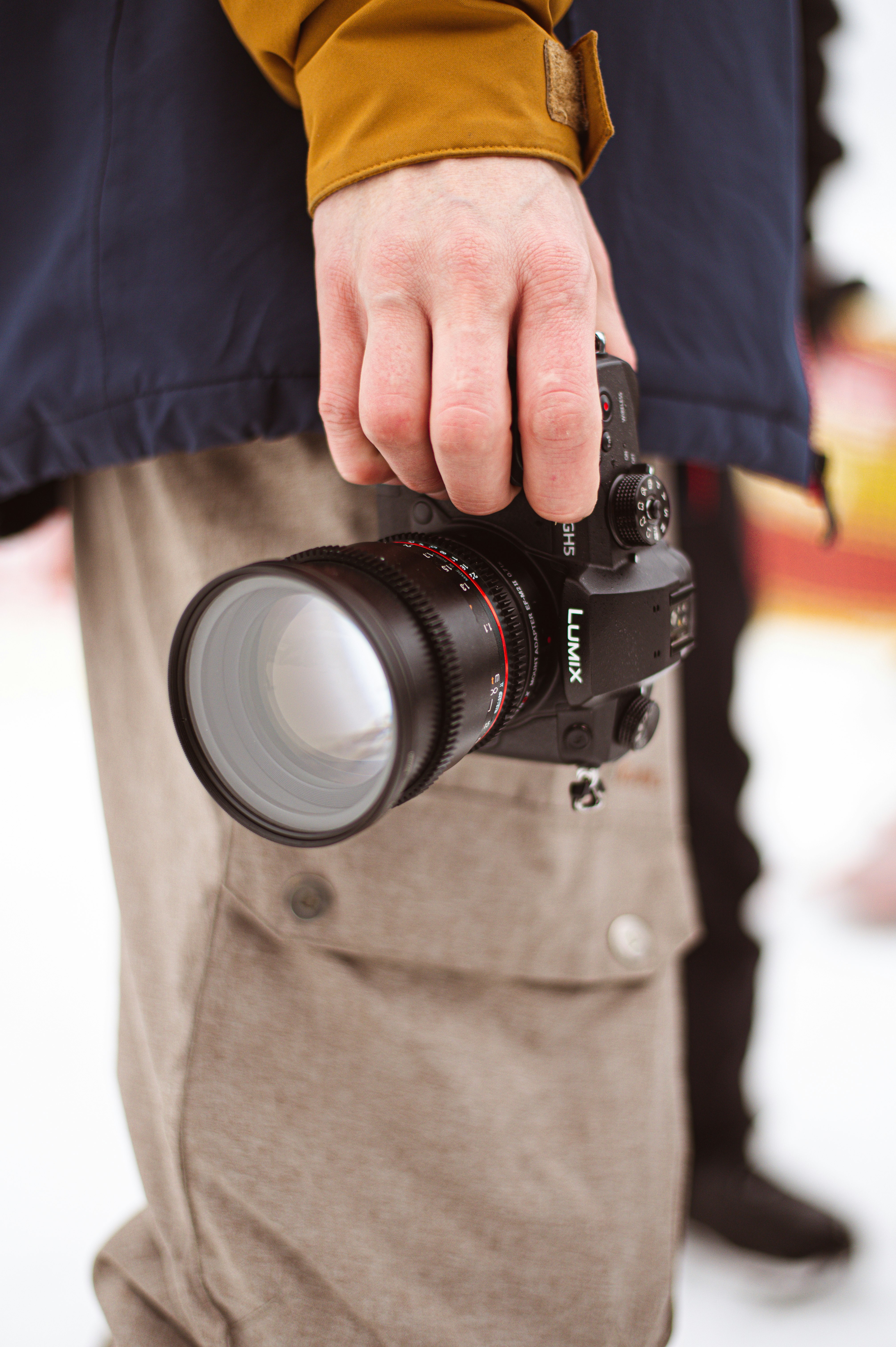 person holding black camera lens